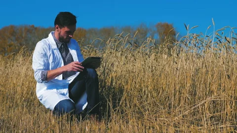 A man is a farmer working in the field. Stock Footage 97327832