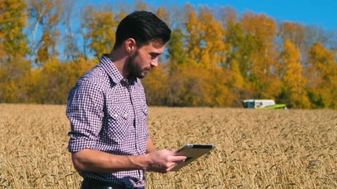 A man is a farmer working in the field. Stock Footage 97328612