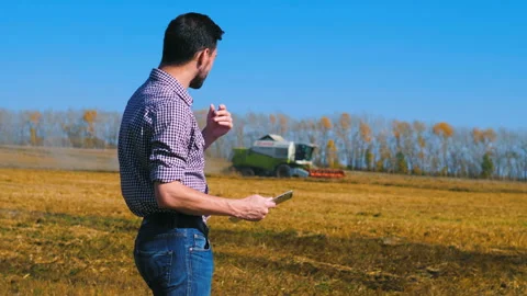 A man is a farmer working in the field. Stock Footage 97328732