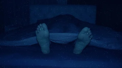 Man is fast asleep, and only his feet twitch weakly sometimes Stock Footage 330870664