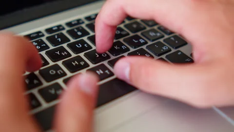 Man fast typing text on a keyboard. Macro shot of a person fast typing on a.. Видео 339858717