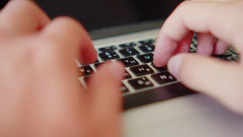 Man fast typing text on a keyboard. Macro shot of a person fast typing on a.. Stock Footage 339858871
