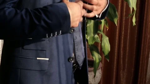 Man fasten buttons on jacket Stock Footage 74882822