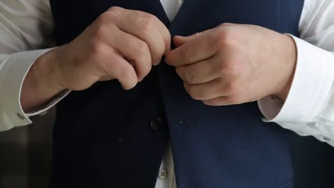 A man fastens his jacket on a button in the morning Video stock 121080595