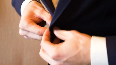 The man fastens his jacket, his hands close up Stock Footage 89648788