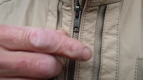 A man fastens his man jacket. Zip up the an jacket Stock-Footage 113625661
