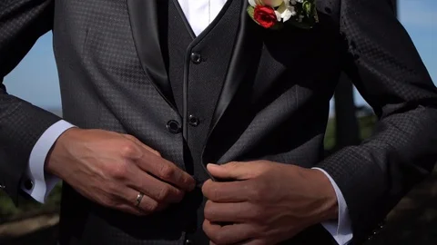 The man fastens his tuxedo.Buttoning a jacket. Stylish man Stock Footage 127433859