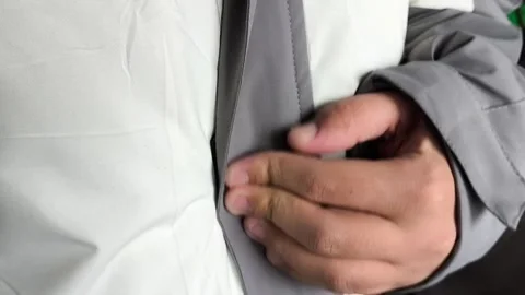 A man fastens the Velcro with the zipper of a winter jacket. Warm Winter Stock Footage 325034026