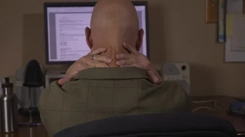 A man with fatigue rubbing his neck while working on the computer Stock Footage 295453944
