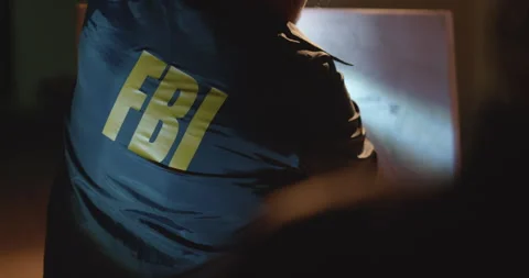 Man in FBI jacket drawing up attack plans on whiteboard. Planning raid. Night Stock Footage 270403138