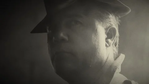 Man in fedora looking at camera in smokey room in black and white Stock Footage 275642187