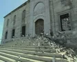 Man feeding pigeons on steps in front of building SD Footage