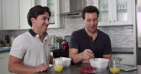Man feeds his boyfriend a raspberry at breakfast, shot on R3D Stock Footage 67327905
