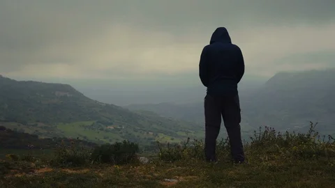A man feeling cold on top of a mountain Stock Footage 88719510