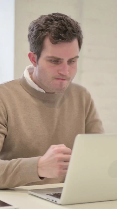 Man Feeling Disappointed While using Laptop, Vertical Video Stock Footage 337351129