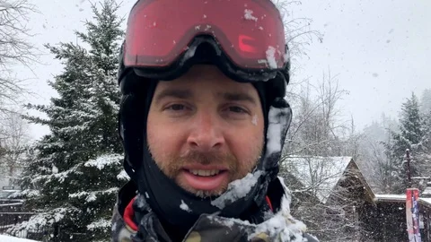 Man feeling happy smiling while it's snowing heavily 動画素材 127518811