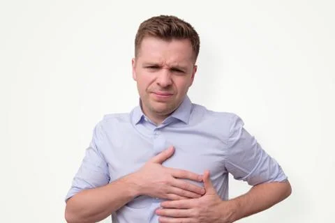 Man feeling having heart attack symptom or breast cancer. Stock Photos