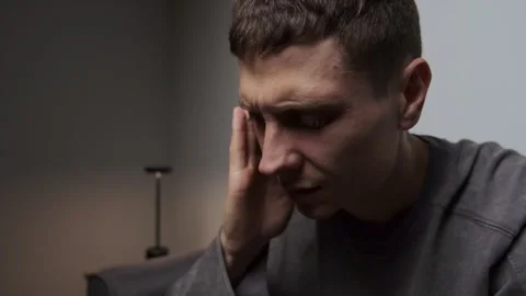 Man feeling headache holding head close up minimal gray background space for Stock Footage 315411560