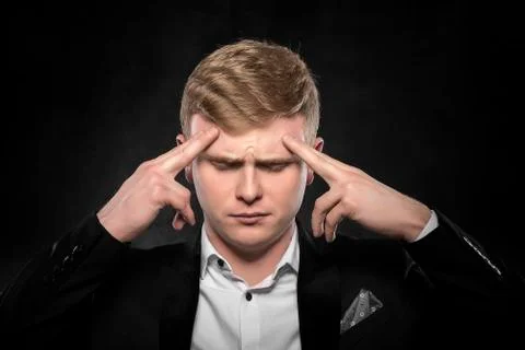 Man feeling a headache or intensely thinking. Stock Photos