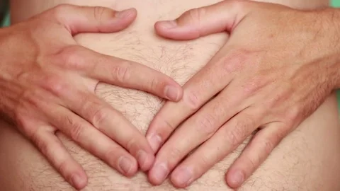 Man feeling his belly closeup 動画素材 74546091