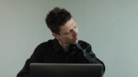 Man feeling neck pain while working on laptop. Uncomfortable working position Video stock 308069725