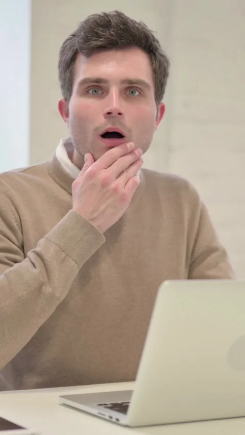 Man Feeling Shocked while using Laptop in Office, Vertical Video Stock Footage 337351440