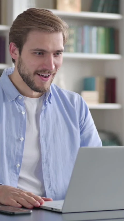 Man Feeling Shocked while using Laptop in Office, Vertical Video Stock-Footage 339577778