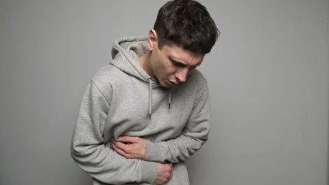 Man feeling sudden strong abdominal stomach ache, gastritis problem. Yung guy Stock Footage 296220825