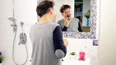 Man feeling tooth pain while washing teeth Stock Footage 82178645