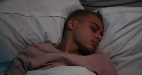 Man feeling uncomfortable sleeping on bed Stock Footage 145295033