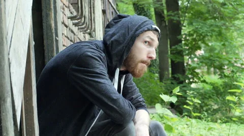 Man feels nervous while checking his drugs next to the abandoned building Stock-Footage 67583062