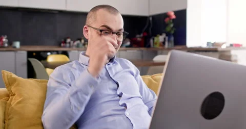 Man feels satisfied with good work results sitting on sofa Stock Footage 304371616