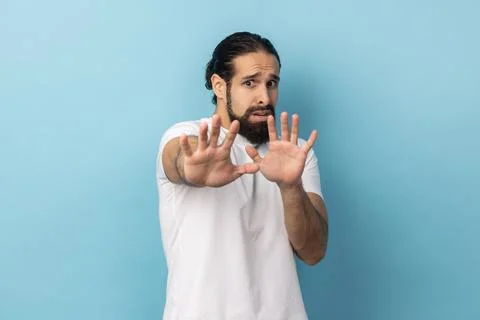 Man feels scared reacts on something looks anxious, having anxiety or being Stock Photos