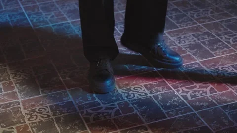 Man feet dancing on dance floor under flashing neon lights Stock Footage 339499576