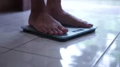 https://images.pond5.com/man-feet-standing-weighing-scales-footage-228764957_iconm.jpeg