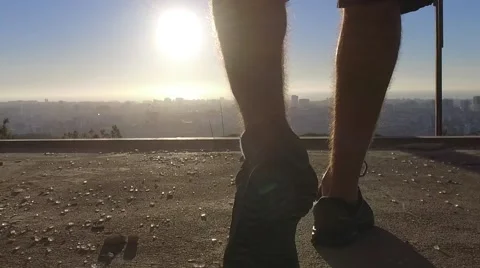 Man feet walking inside abandoned building towards sunrise gimbal slowmotion Stock Footage 67359554