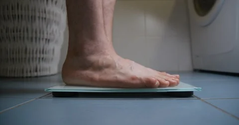 Man feet on weight machine Stock-Footage 93275702