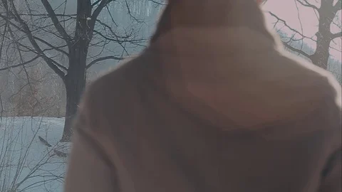 A man in a felt hat and coat comes in the winter woods. brown hat made of felt Stock Footage 72411197