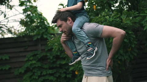 The man felt the pain rolling his son on his shoulders Stock Footage 160948369