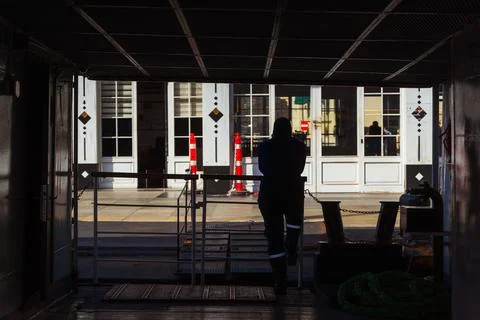 A man on a ferry while docking at a pier in Istanbul Stock Photos