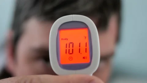 Man with Fever Being Tested By Using an Infrared Thermometer, taking temperature Stock Footage 152724365