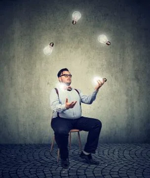 Man fiddling with ideas Stock Photos