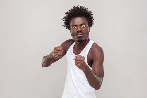 Man fighting with someone, looking at camera, clenched fists, has furious facial Stock-Fotos