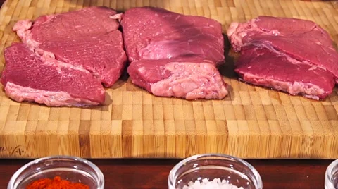 Man fights off raw meat beef steak before frying it slow motion Stock Footage 66448851