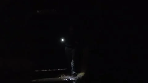 Μan figure with a flashlight in a dark tunnel 스톡 동영상 163592581