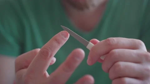 Man files nails with a nail file Stock Footage 164252184