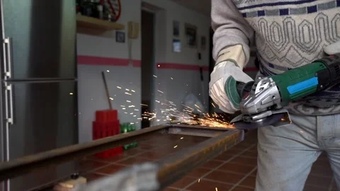 Man filing metal in his workshop while setting off many sparks with the radia Stock Footage 146602289