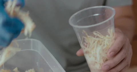 Man filled a recycled plastic cup with dried sugarcane stems Video stock 240690852