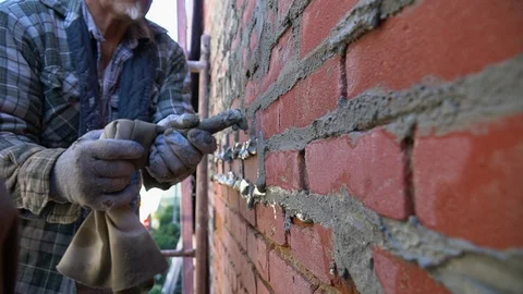 A Man Filling The Brick Wall Gaps With Mortar Mix In Boise, Idaho - Stock Footage 129018816
