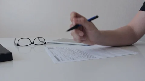 Man fills up documents Stock Footage 89094373